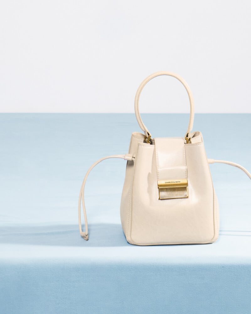 Women’s Charlot elongated bucket bag in oat - CHARLES & KEITH