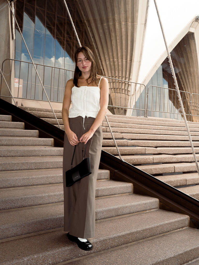 Women’s pointed-toe Mary Jane slingback pumps in burgundy & bow elongated trapeze shoulder bag in meringue white, as seen on Annabel Wolfe – CHARLES & KEITH