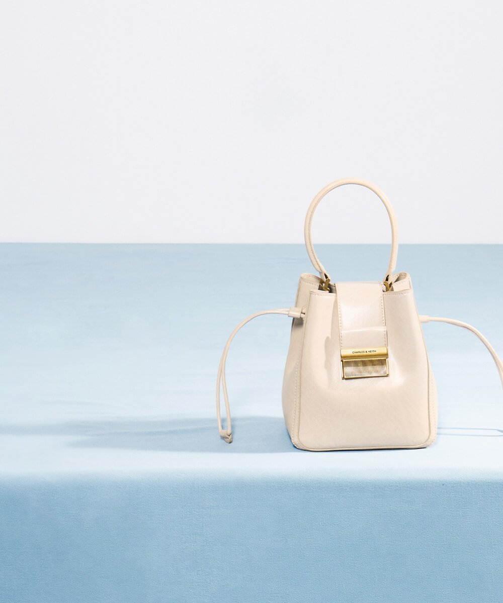 Women’s Charlot elongated bucket bag in oat – CHARLES & KEITH